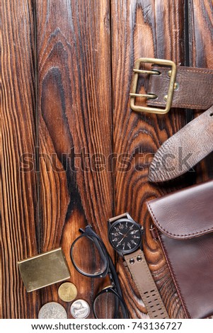 Leather accessories of the photographer on a brown wooden background