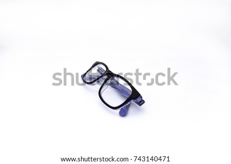 Pair of blue and black folded spectacles, on white background.