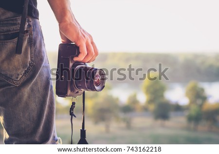 Photographer's hand with camera 