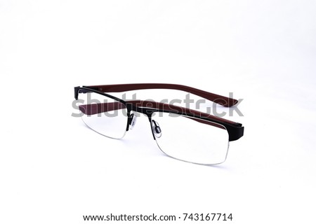 Pair of red and black partially folded spectacles, on white background Royalty-Free Stock Photo #743167714