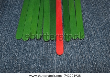 Many green stick but just one red stick