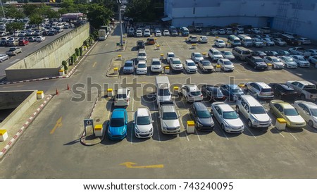 Cars on an outdoor parking lot in department store. All trademark removed. Royalty-Free Stock Photo #743240095
