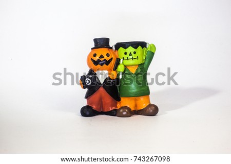 Happy Halloween resin toys for kid look cute and funny style presents by pumpkin Jack and his friend frankenstein  playing trick or treat holding the camera.isolate white background.front view