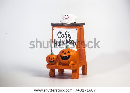 Happy Halloween pumpkin head playing trick or treat on the coffee shop plate  resin toy  side left view ,isolate white background