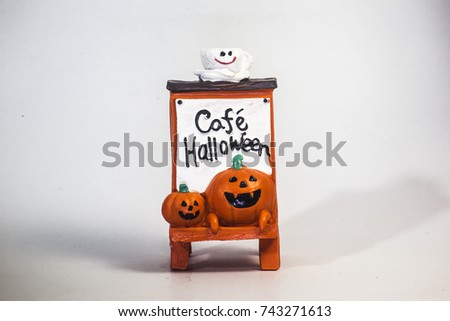 Happy Halloween pumpkin head playing trick or treat on the coffee shop plate  resin toy  side left view ,isolate white background