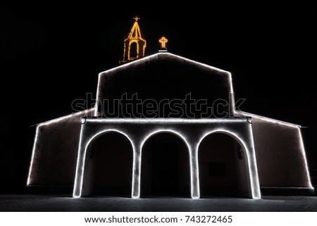 Profile of a church with christmas lights at night. Christmas background