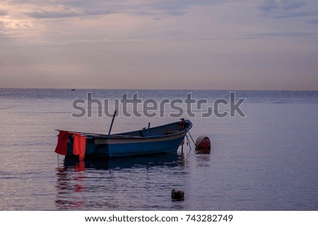 fishing boat at anchor in the calm