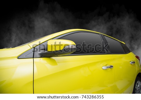 Yellow Car windows and side mirror isolated on black background. with smoke and fog
