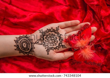 Oriental picture on woman hand palm, horizontal banner. mehendi traditional decoration, resistant design, brown henna tattoo art. Saloon service style, mandala lily flower, bright red cloth background
