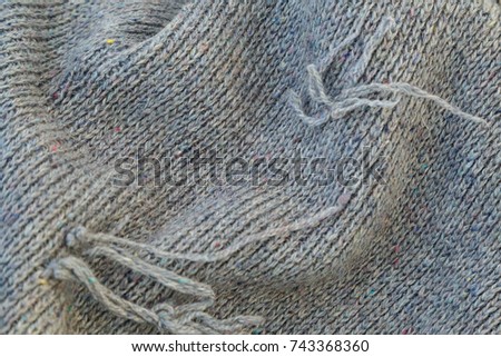 background of knitted gray linen of goat's wool made with knitting needles or on a knitting machine laid in big waves.