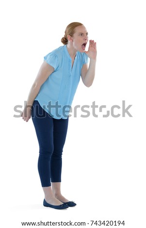 Angry female executive shouting against white background