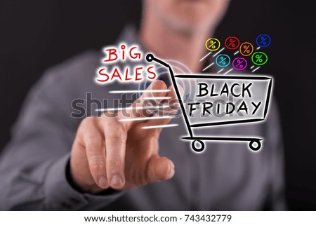 Man touching a black friday concept on a touch screen with his finger