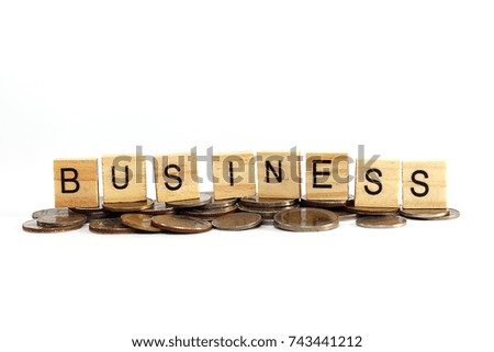 Small wooden plate with the letters arranged on a coin "BUSINESS" business management.