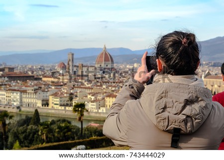 A tourist takes a picture of the beautiful cityscape of Florence from the ''Piazzale Michelangelo''