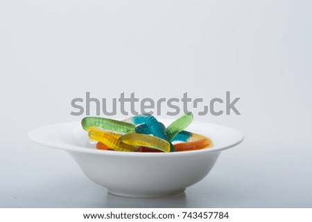 Colorful Jelly Worms Snakes isolated in bowl isolated for Halloween decoration