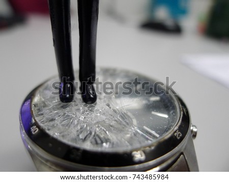 business man figurine  stepping on cracked glass