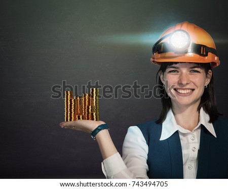 Business woman  with helmet mine and stacks of bitcoin coins. Studio shoot. Mining cryptocurrency concept