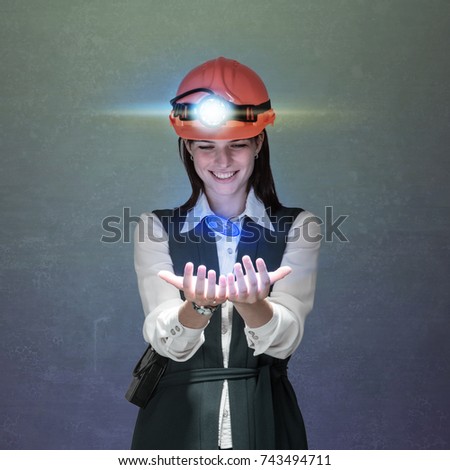 Business woman in  helmet mine with a bitcoin sign in hands. Studio shoot. Mining cryptocurrency concept