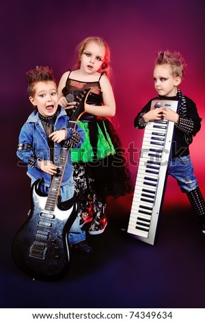 Group of children singing in heavy metal style. Shot in a studio.