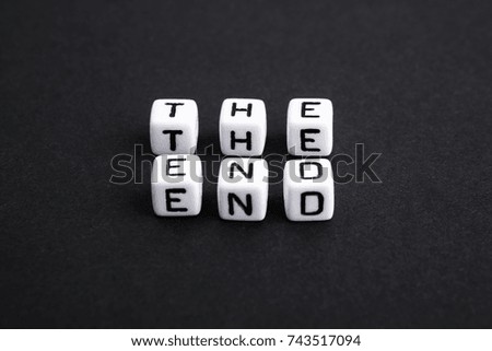 The end made of plastic cubes. Black and white.  A series of minimalism conceptual phrases and words. Horizontal. 