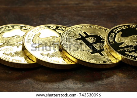 Bitcoin in a row of 1 ounce American gold eagle bullion coins
