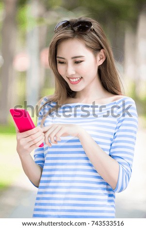 woman smile and use phone in the park