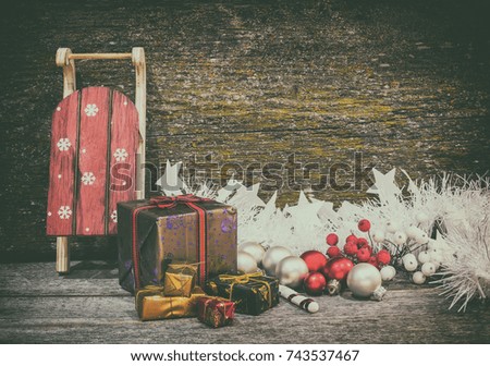 Christmas gift boxes and sleigh with presents on an old wooden surface, space for text, retro style
