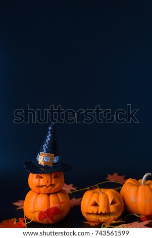 happy halloween, pumpkins for halloween on dark background, a big black witch hat