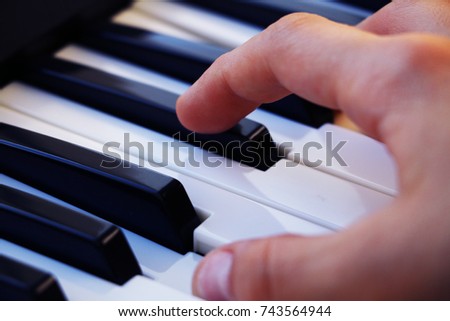 hands play the piano keys music notes