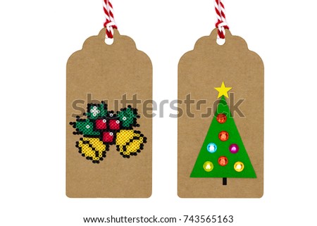 3D Paper craft tags,Gold christmas jingle bells with holly coloring made from mini beads,christmas tree and big lighting star decorations.White isolation.Top view,flat lay.Selective focus.