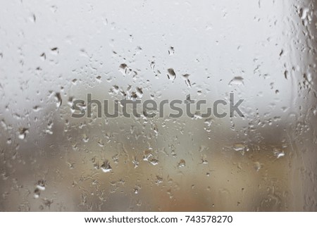 Rain drops on the wet window. Gray dampness