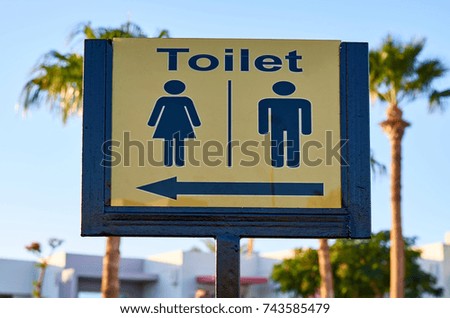 public toilet sign at the sea beach.
