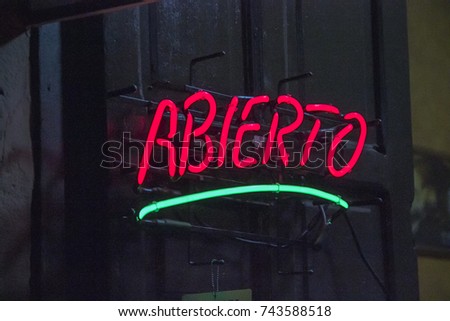 neon sign with the word open Installed in an old wooden door