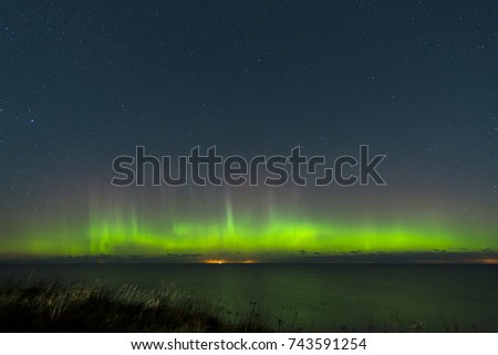 Beautiful aurora borealis, northern lights over Finnish gulf.