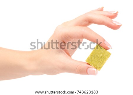 Dry cube of broth female hand on a white background isolation