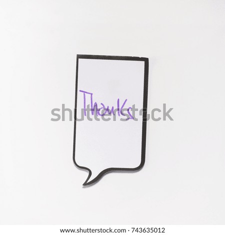 a white memo pad with the shape of a comic with the inscription "thanks"