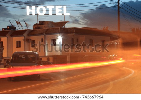 Hotel. Unrecognizable building in night view with car lights