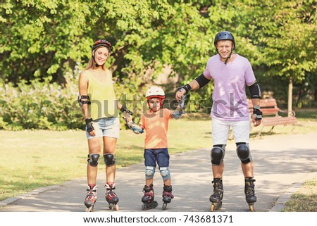 Family on roller skates in summer park