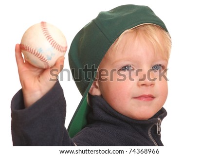Portrait of a toddler showing a baseball