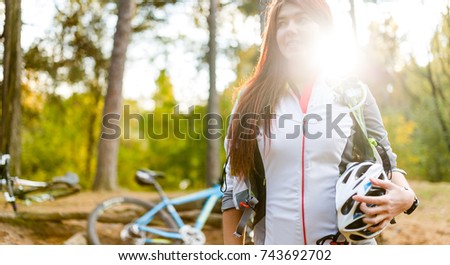 Image of young athlete with helmet on background of bicycle