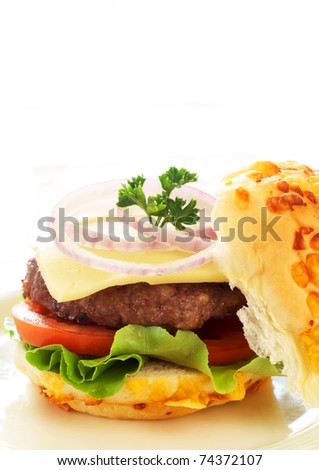 Tasty hamburger with grilled patty, tomato, cheese and lettuce on white background