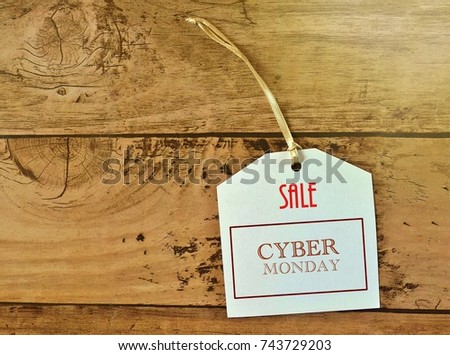  photo of screen showing Sale Tag for cyber monday event on on wooden table  with ray of light on the right side