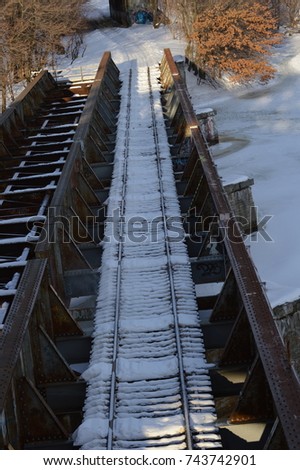 vertical horizon photography railway railroad train tracks cover with a soft layer with white snow rustic rusted old abandoned street urban over a frozen lake river ocean water lake sea