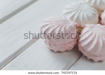 Sweets, dessert, marshmallows on a white wooden background.

