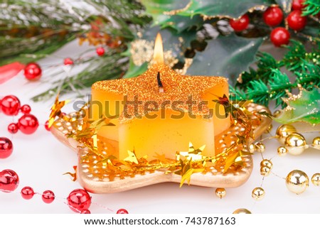 Christmas candle and decoration on gray background.