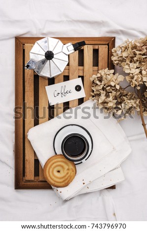 Good morning coffee with love.Top view coffee and biscuits in the bed on a cozy lazy sunday.