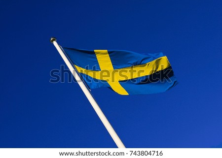 Sweden, Swedish Standard, outdoors. Blue and yellow, sky and sun.