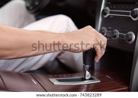 Driver's hand on gear lever, closeup
