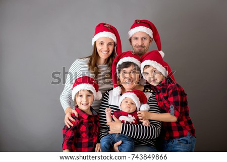 Family christmas portrait, isolated on gray, studio image, people with santa hat