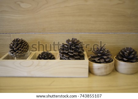 Brown pine cones on wooden table, stock photo